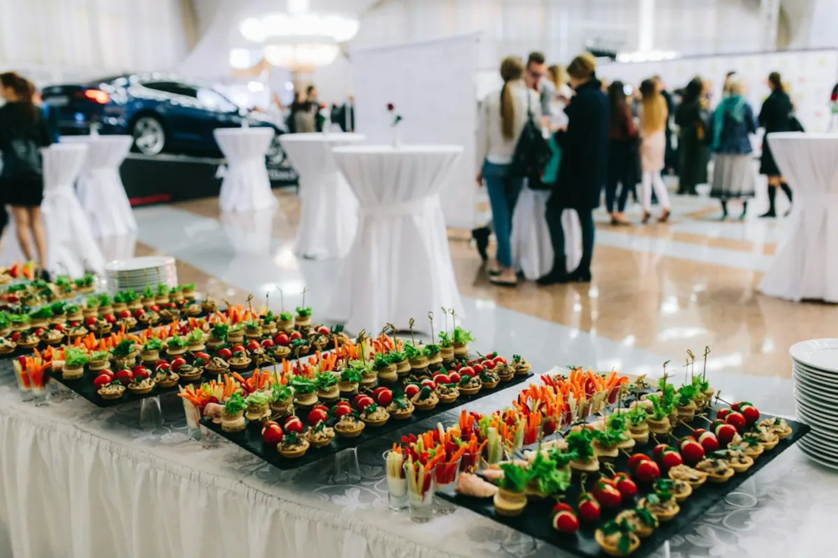 Catered reception buffet with trays of canapés in a banquet hall